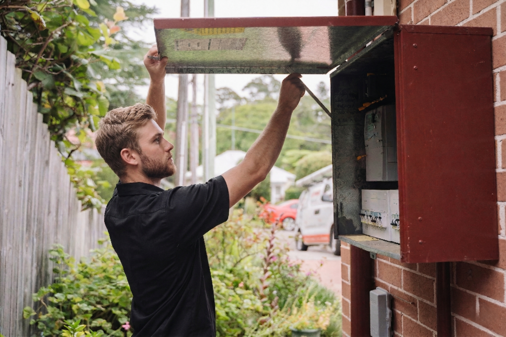 Electrician installing downlights in a Strathfield home
